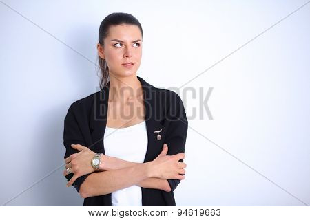A young woman standing, isolated on graybackground