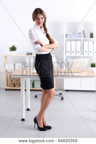 Attractive businesswoman with her arms crossed stnding