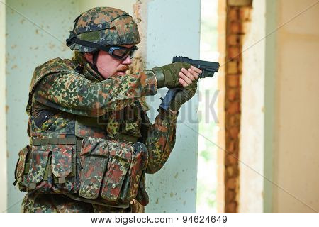 military. soldier with pistol in nato germany uniform indoors