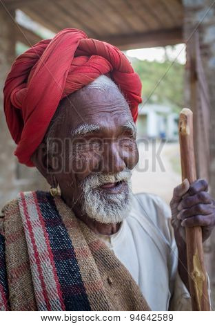 GODWAR REGION, INDIA - 13 FEBRUARY 2015: Blind Rabari tribesman holds stick in courtyard. Rabari or Rewari are an Indian community in the state of Gujarat.