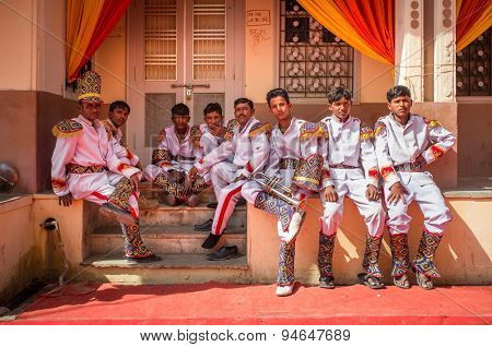 GODWAR REGION, INDIA - 15 FEBRUARY 2015: Wedding ceremony band members relax after practice.