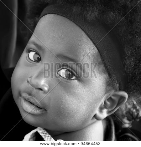 Accra, Ghana - July 1, 2014.  Unidentified Ghanaian Little Girl With Big Eyes. People Of Ghana Suffe