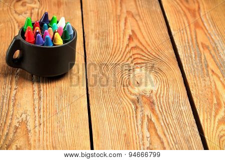 Crayons In A Mug On A Wooden Table