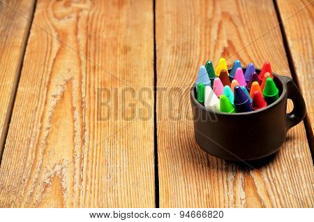 Crayons In A Mug On A Wooden Table