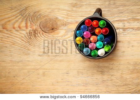 Crayons In A Mug On A Wooden Table