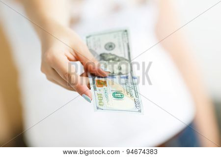 Hand Of Woman Giving Money