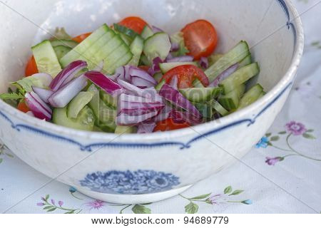 Sallad In A White And Blue Bowl