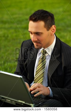 Jovem empresário com o Laptop em um parque
