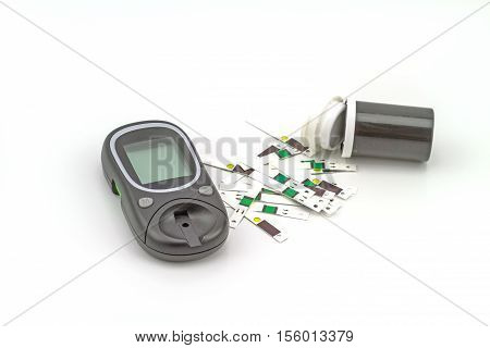 Many strip test of blood glucose meter the blood sugar value is measured on a finger on white background