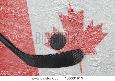 Hockey puck stick and the image of the Canadian flag on the ice. Concept hockey