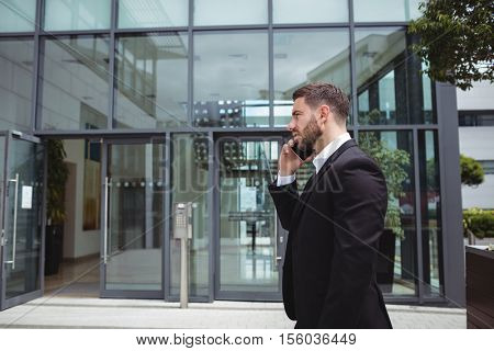 Businessman talking on mobile phone in office premises