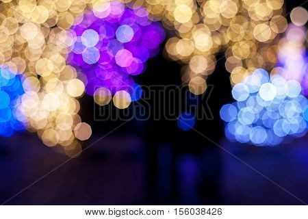 blurry lights Christmas tree with great outlines of silhouettes congruent in front of her people