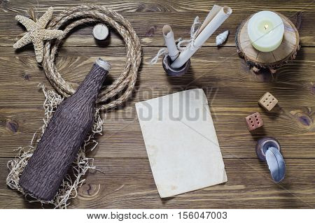 The concept of writing a letter on a ship travel sea adventures top view. Vintage writing set feather quill ink desk and blank antique paper flat lay.