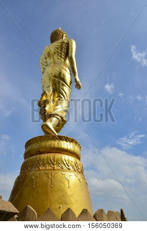 Golden Buddha statue standing on a mountain Wat Phra That  Khao Noi, Nan Province, Thailand