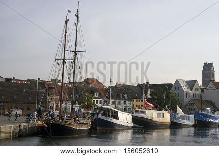 WISMAR GERMANY - OCTOBER 14 2016: Part of the old harbor in Wismar with fishmonger boats at dock. View from seaside. October 14 2016 Germany.