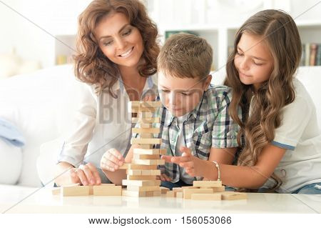 Portrait of a mother and children play Jenga