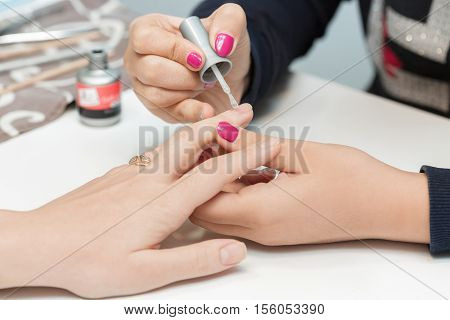 specialist beauty salon applying Polish nails to women nails