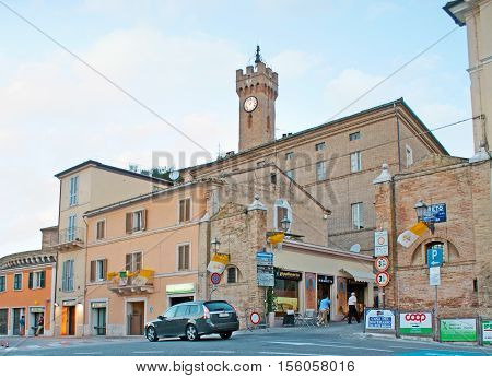 LORETO ITALY - OCTOBER 6 2012: The walk outside the city wall with the view on shops stalls cafes and the old clock tower rising above the houses on October 6 in Loreto.