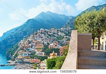 Positano resort boasts amazing views on the old town on the rock lush mediterranean gardens cozy beach nice cafes medieval Cathedral and numerous boats always ready for the trip Italy.