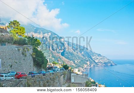 The traffic jam on the narrow serpentine road on Amalfi Coast connecting famous resorts of Campania Italy.