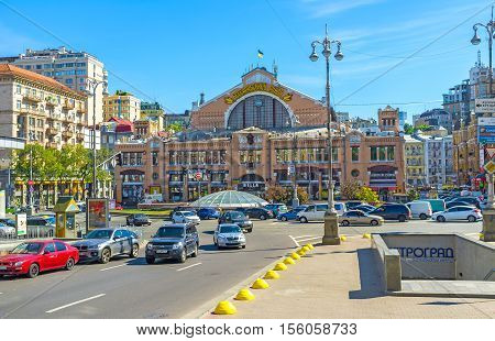 KIEV UKRAINE - SEPTEMBER 8 2016: The historic indoor covered market of Bessarabka and Khreshchatyk Avenue full of cars on September 8 in Kiev.