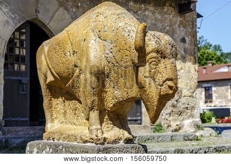 Santillana Del Mar Spain - August 23 2016: Sculpture Bison Jesus Otero near the houses of the Vine and the Eagle in Santillana del Mar. Cantabria