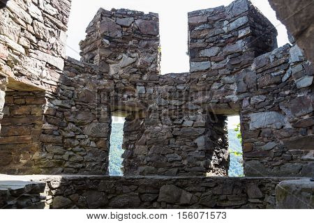 Ruins of ancient round stone guard tower with loopholes - inside view . Reichenstein Castle Rhine Valley Germany - UNESCO World Heritage