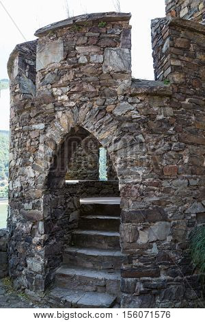 Ancient watchtower round stone tower with arched entrance and staircase. Reichenstein Castle Rhine Valley Germany - UNESCO World Heritage
