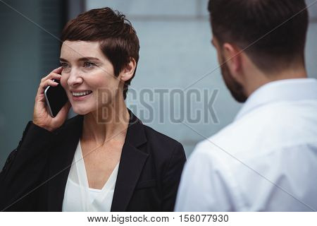 Businesswoman talking on mobile phone in office premises