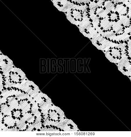 White vintage lace as a frame on black background
