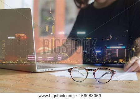 Double Exposure Of Building Constructure And Image Of Business Women Working With Laptop Computer In