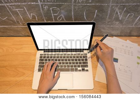 Office Desk Mockup: Laptop, Smart Phone, And Cup Of Coffee And Notebook With Business Financial Grap