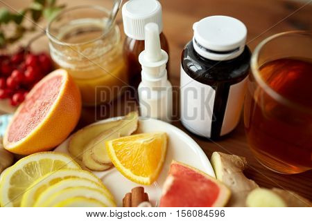 healthcare, traditional medicine, flu and ethnoscience concept - natural remedies and drugs on wooden table