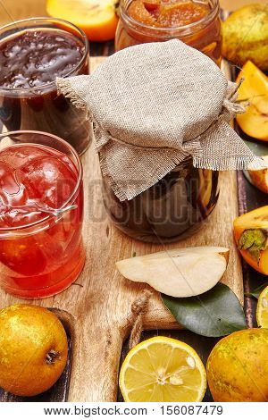 Berry and fruit jam with ingredients on a dark rustic background.