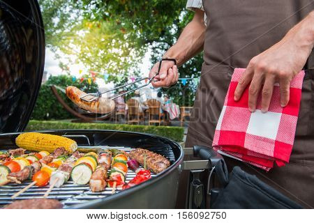 Family having a barbecue party in their garden in summer