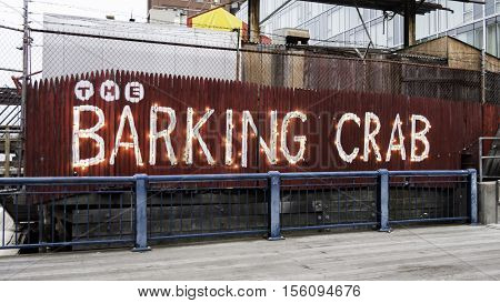 South Boston Massachusetts USA - December 17 2015: Casually creative sign announces the location of The Barking Crab a popular restaurant along the Harborwalk in South Boston
