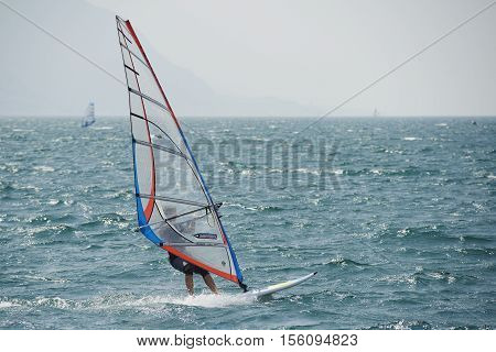 Torbole - Nago, Lago di Garda (Lago Benaco), Italy - August 11, 2015: A windsurfing on Lake Garda in Torbole resort.