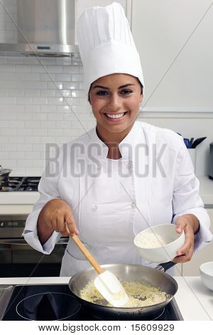 Chef cooking a tasty  risotto  in a modern kitchen