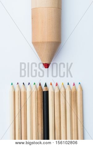 small pile of crayons and one huge crayon