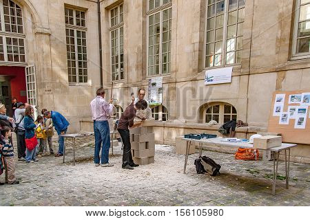 PARIS, FRANCE. Circa april 2016. Exhibition of artisans stone sculptor of the association rempart making a sculpture in stone in Paris