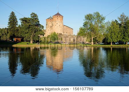 View of Olavinlinn's fortress on the Saimaa lake in the August evening. Savonlinna, Finland