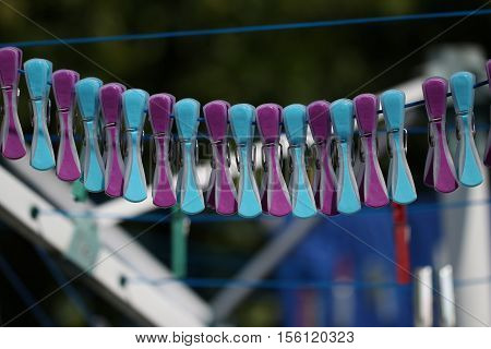 Close up of a colored clothespins on a clothesline