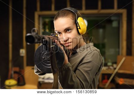 The woman at the shooting range shot from a rifle.