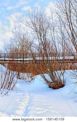 wooden pedestrian bridge over the frozen river