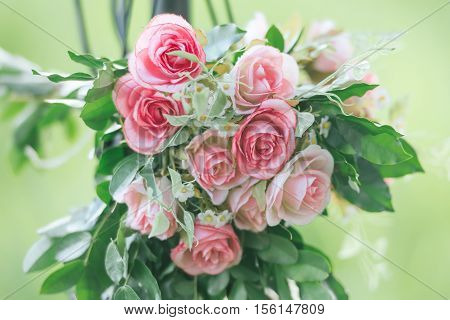 Pink fabric rose flowers bouque vintage on green background with copy space
