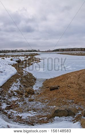 water freezes on the river bank in November