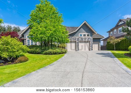 Custom built house with trimmed lawn, yard on a sunny day