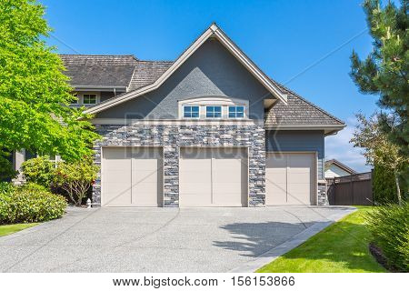 Custom built house with trimmed lawn, yard on a sunny day
