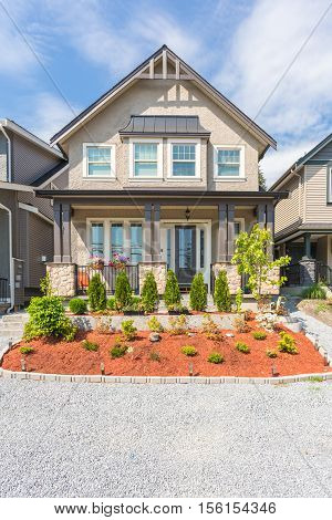 Custom built house in the nice neighbourhood on a sunny day.