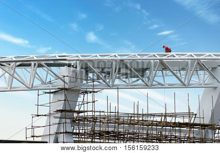 Steel roof construction sites workers at height.